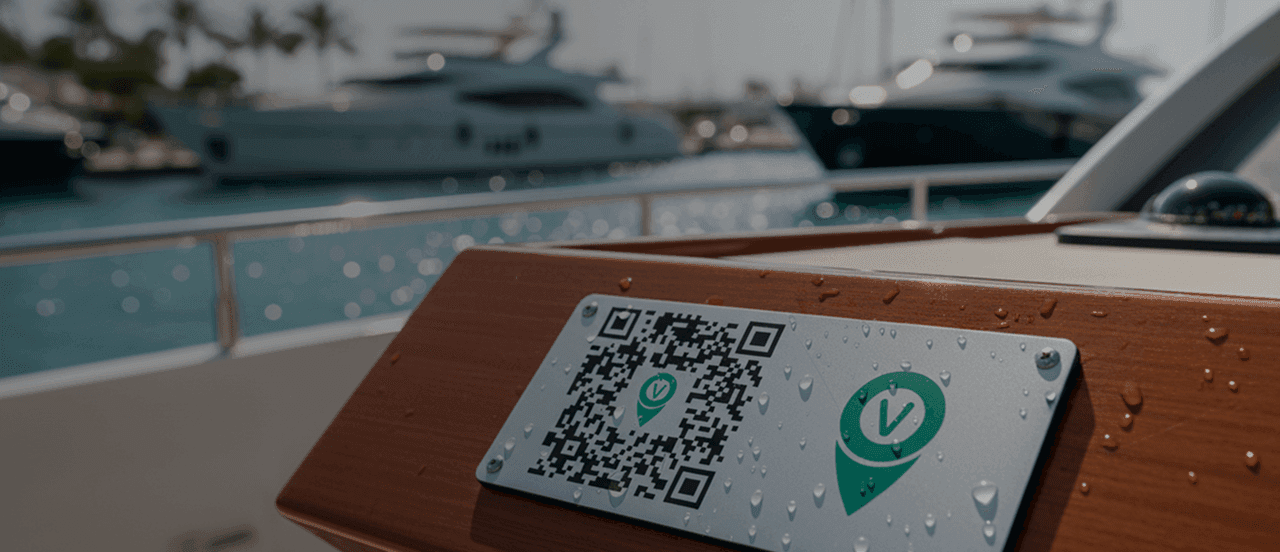 A QR code and green logo on a metal plate mounted to the wooden railing of a boat.