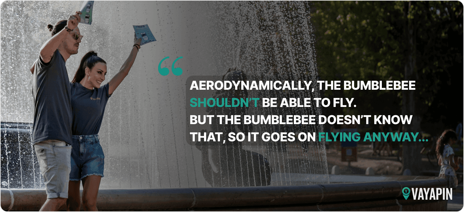 A VayaPin team celebrates by a fountain